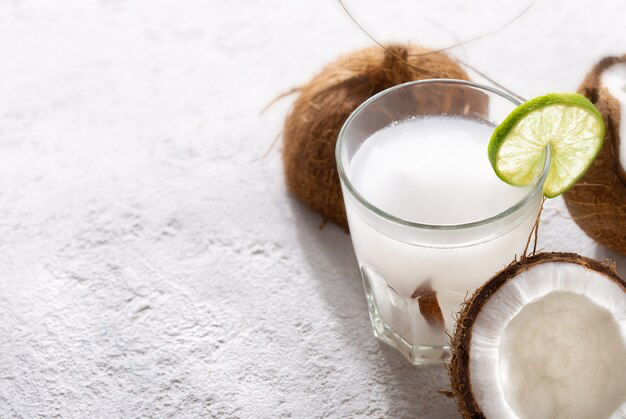 Coconut tonic in a glass cup on a light background