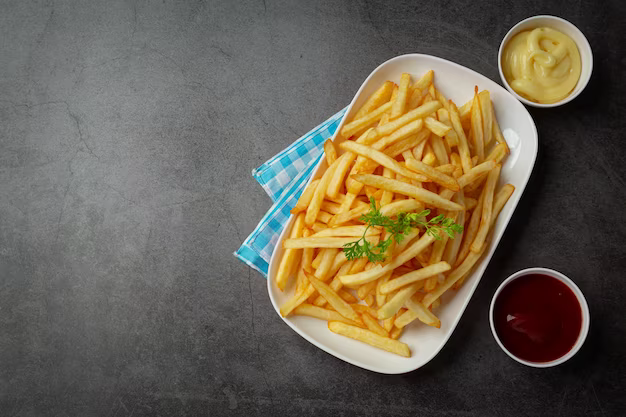 Crispy French fries with ketchup and mayonnaise, top view