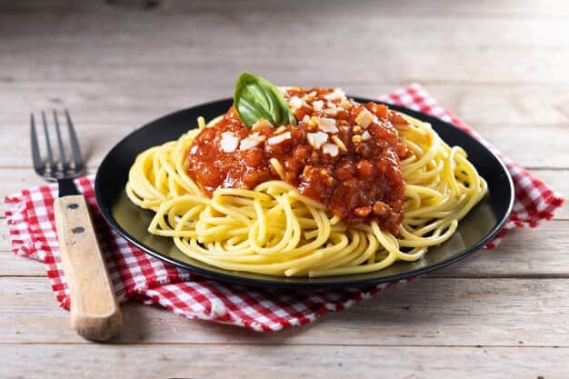 Spaghetti with Bolognese sauce on a wooden table