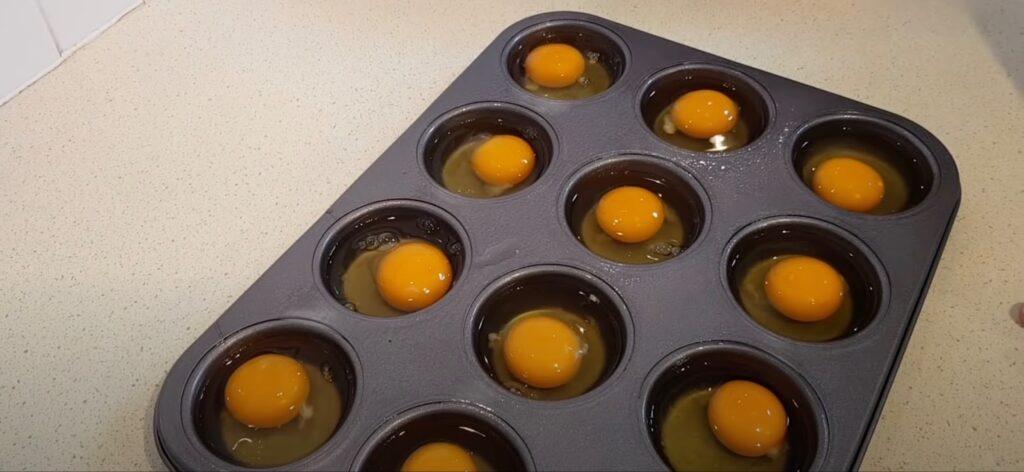 Raw eggs in a muffin tin