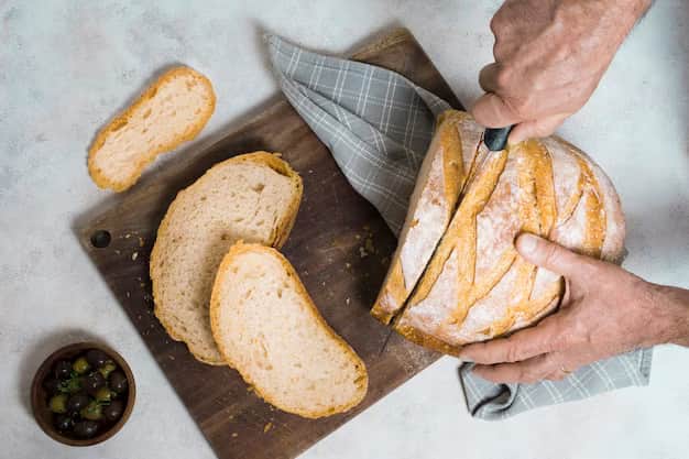 Man cutting slices of bread