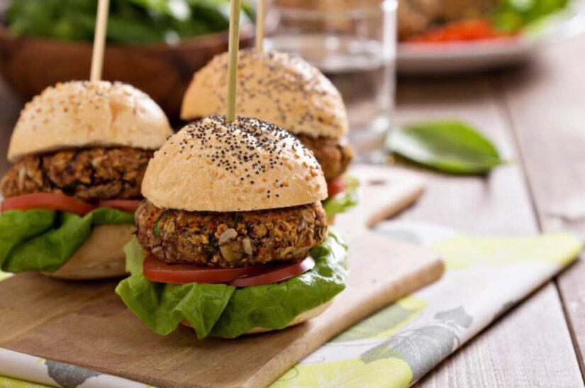 Vegetarian mung bean burgers served on poppy seed buns with greens