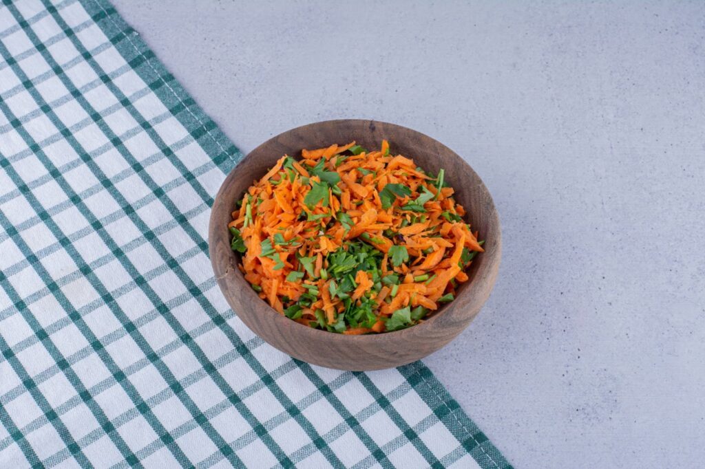 Carrot dill salad in wooden bowl