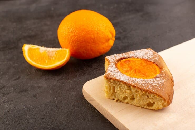 Slices of Cake with Sliced and Whole Citrus